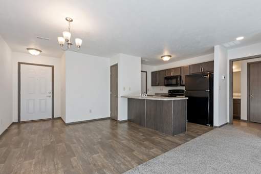 A kitchen area with a refrigerator, microwave, and oven.