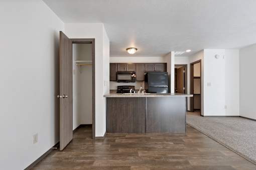 A kitchen with a wooden floor and white walls.