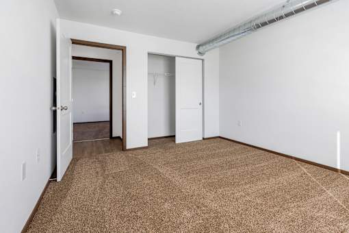 A room with a carpeted floor and white walls.