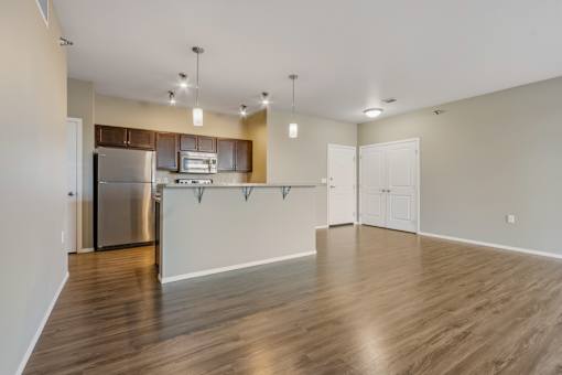 A kitchen with wooden floors and white walls.