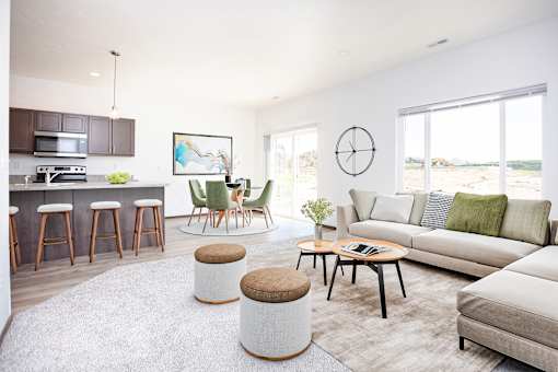 A modern living room with a bar area and a large window.