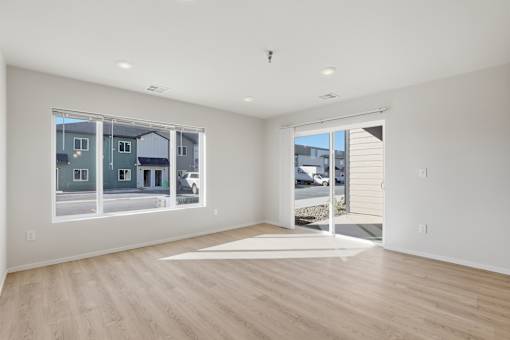 A large empty room with a view of the street outside.