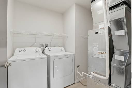 A white washing machine and dryer in a small laundry room.