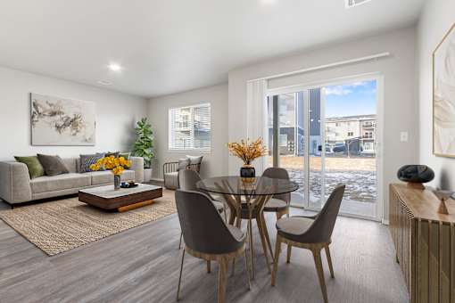 A modern dining room with a glass table and chairs.