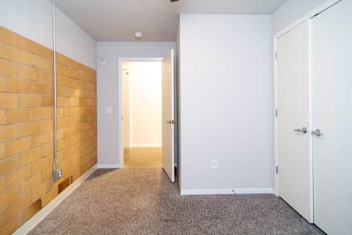 A room with a white door and a white cabinet.