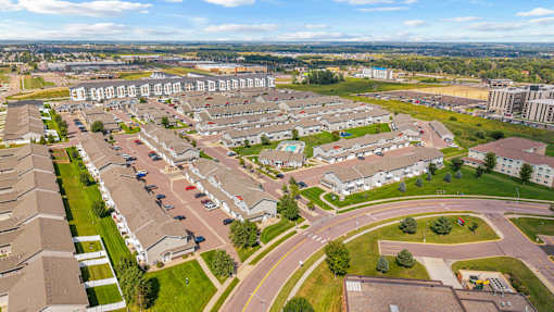 A residential area with houses and a parking lot.