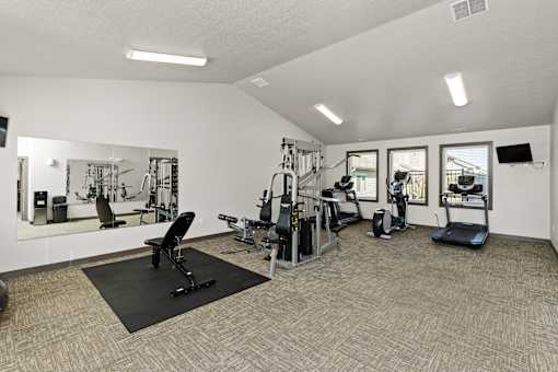 A spacious home gym with a variety of equipment.