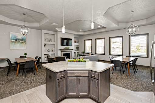 A kitchen with a large island and a dining table.