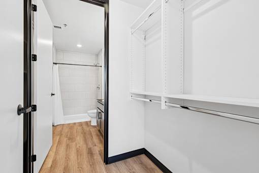 A white bathroom with a walk in shower and a toilet.