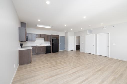 A kitchen area with a counter and cabinets.