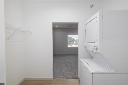A white kitchen with a microwave and oven built into the cabinetry.