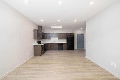 A kitchen with wooden floors and white walls.