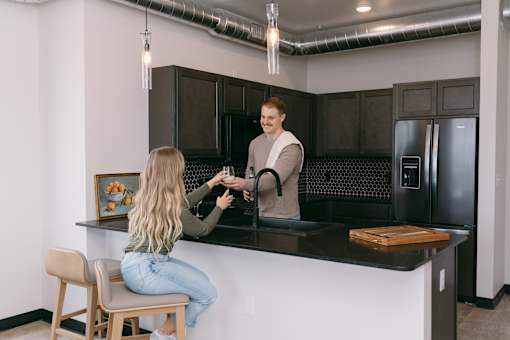 A man is serving a woman at a bar.