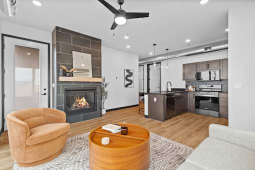 A modern living room with a fireplace and a brown armchair.