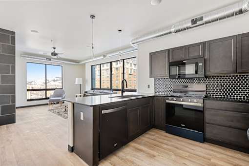 A kitchen with dark wood cabinets and a large island.