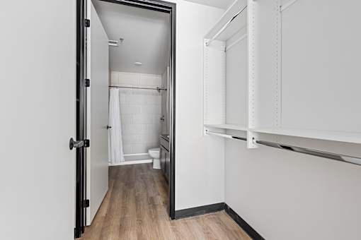 A white bathroom with a toilet, sink, and shower.