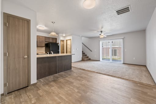 Spacious, combined kitchen and living room with breakfast bar seating.