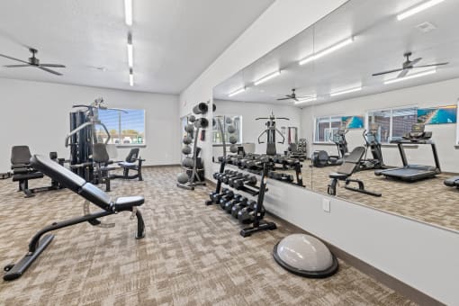 Modern gym with rows of cardio equipment.