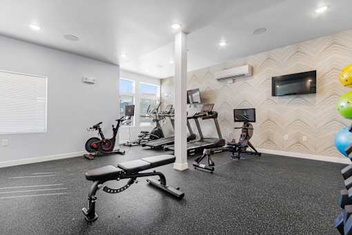 A spacious home gym with a variety of exercise equipment.