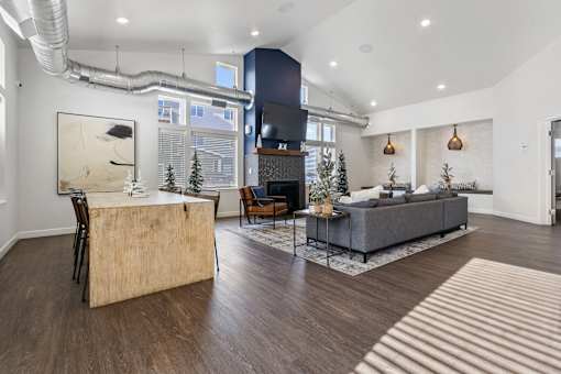 A modern living room with a wooden floor and a large window.