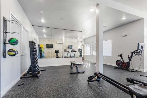 A spartan room with a row of exercise equipment.