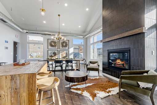 A modern living room with a fireplace and a cowhide rug.