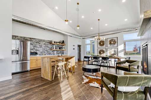 A modern kitchen with wooden floors and a stone backsplash.