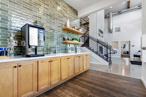 A kitchen with wooden cabinets and a glass-fronted coffee machine.