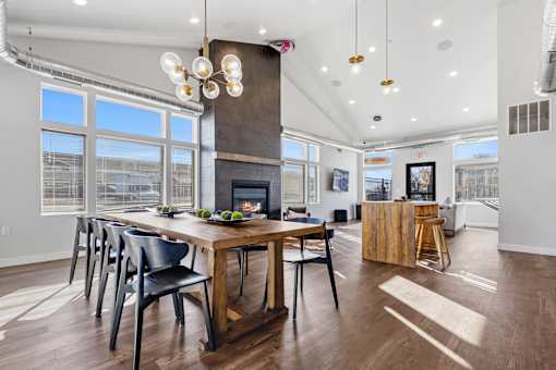 A modern dining room with a wooden table and chairs.