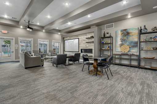 A modern living room with grey flooring and furniture.
