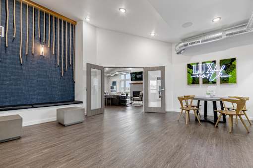A room with a wooden floor and a blue wall with a white ceiling.