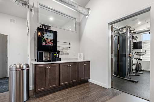 A room with a TV, a trash can, and a gym setup.