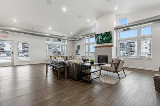 A living room with a fireplace and a television on the wall.
