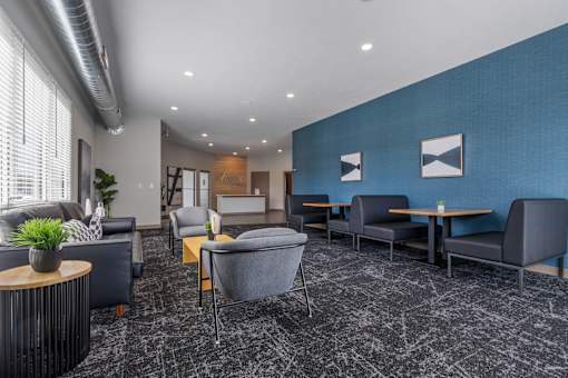 A modern waiting room with grey and blue accents.