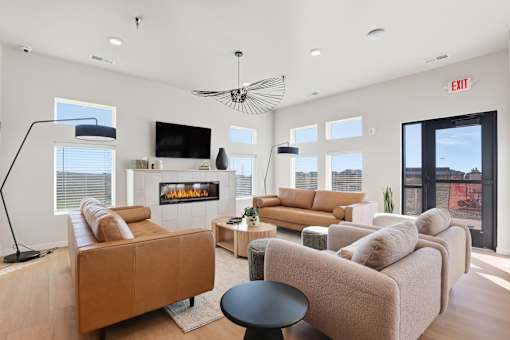 A living room with a fireplace and a flat screen TV.