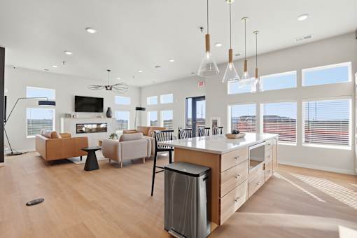 A modern kitchen with a large island and a dining area.