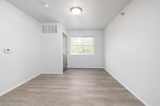 A room with a window and a door.