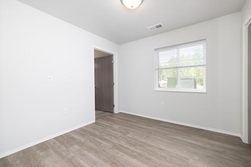 A room with a window and a door.