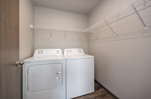 Two washing machines in a small laundry room.