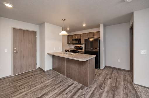 A kitchen with a wooden floor and a countertop.