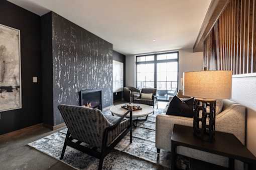 A living room with a fireplace and a chair.