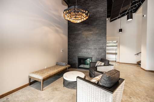 A modern living room with a fireplace and a chandelier.