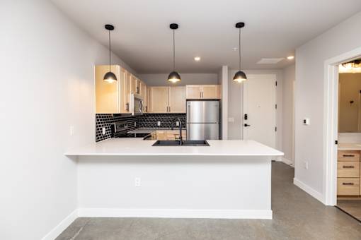 A modern kitchen with a large island in the middle.