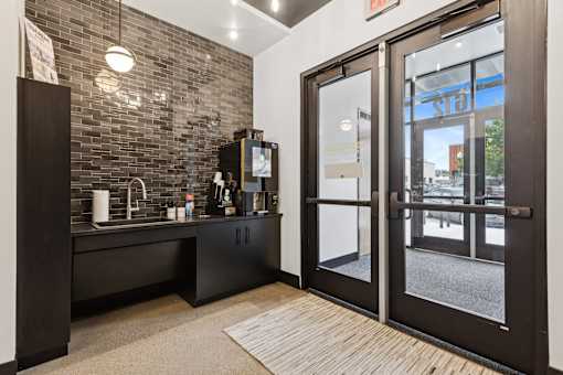 A black and white kitchen with a glass door entrance.
