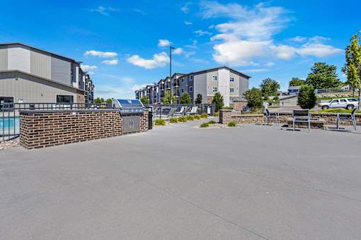 A parking lot with a building and a wall in the background.