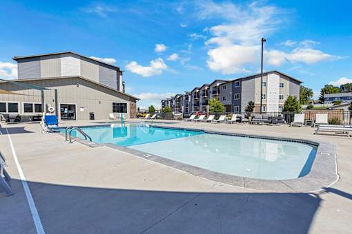 A swimming pool in a sunny outdoor setting.