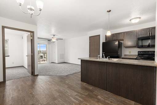A kitchen area with a microwave, oven, and sink.