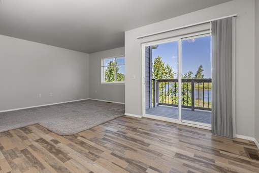 A room with a sliding glass door leading to a balcony.