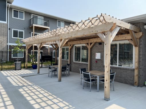 Outdoor kitchen area with barbecue and dining table.
