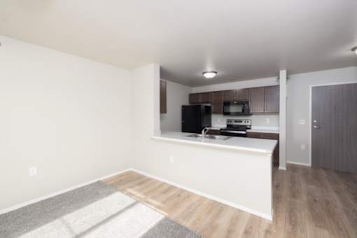 A kitchen area with a countertop and cabinets.
